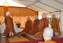 Luang Por Viradhammo lights incense at the start of Samanera Khema's ordination ceremony
