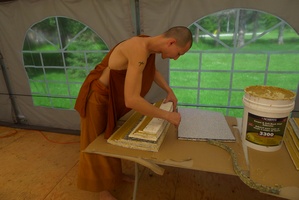 Ajahn Dtum works on a meditation cushion