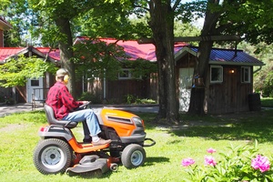 Peters gives the grounds a mow in preparation for Luang Por Liem's viset