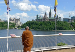Luang Por Liem takes a look at the Parliament buildings from the Museum of Civilzation in Quebec