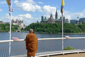 Luang Por Liem takes a look at the Parliament buildings from the Museum of Civilzation in Quebec
