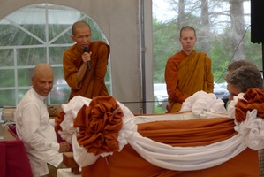 Tan Suvijjano reads the Thai script on the stone to be embedded in the upcoming meditation hall