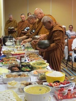 Bhikkhus take almsfood at a dana in Mississaga