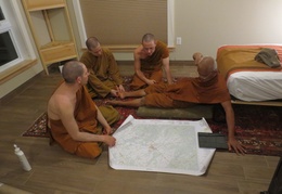 Luang Por Liem and the Sangha look at a map of the Perth area.  L to R: Tan Cunda, Samanera Khema, Tan Thaniyo, Luang Por Liem