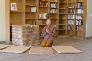 Tan Suvijjano in front of the mats he completed for Ajahn Jayanto