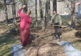 Ven. Muditavihari and Adrien work to clear underbrush near the house