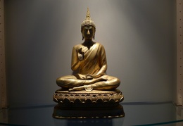 A Thai-style Buddha image with hands in the teaching posture.  Displayed in the Bhikkhu Vihara