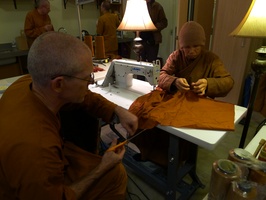 Venerables Khemako and Suvijjano work on the Kathina robe