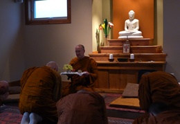 Luang Por Viradhammo offers a tray to Luang Por Pasanno before his departure to Abhayagiri monastery