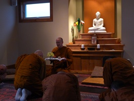Luang Por Viradhammo offers a tray to Luang Por Pasanno before his departure to Abhayagiri monastery