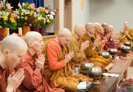 Assembled monastics chant the meal blessing