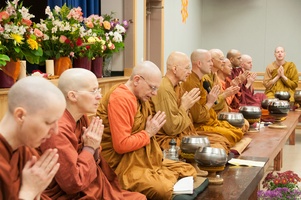 Assembled monastics chant the meal blessing