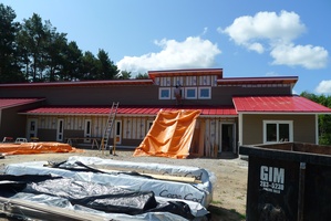 A view of the front.  The roof is on and the siding is coming up