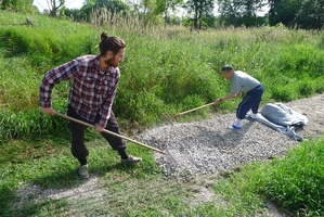 Jacquelin and Steve rake out gravel for our new paths