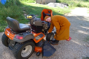 Samanera Khema keeps the mower in good working order