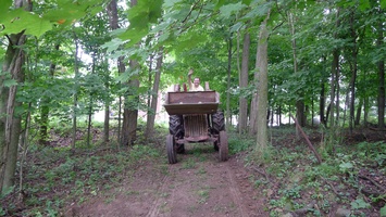 The tractor on the way lay gravel on the path to the field