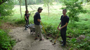 Peter and his crew rake gravel out on the path