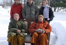 Ajahn Kusalo, Ajahn Viradhammo and guests take a photo in the snow