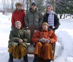 Ajahn Kusalo, Ajahn Viradhammo and guests take a photo in the snow