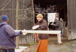 Wood for the new hall is moved indoors