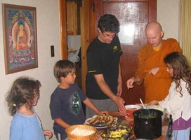 Andre and the kids help to offer the meal to Bhante Khemaratana