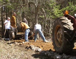 A crew gets to work on improving the road behind the house