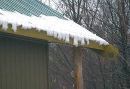 As the weather warms the snow slides off the roofs in sheaths