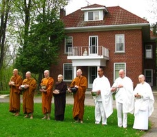The assembled Sangha chants the meal blessing on Vesak, 2009