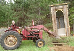Moving outhouses is not a problem for the ol' tractor