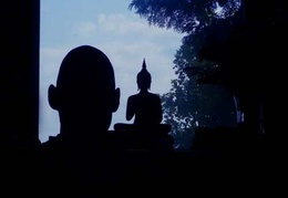 A silouette of Ven. Sumangalo and a Buddha image