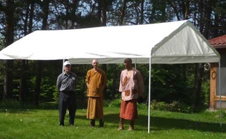 L to R: Crawford, Ven. Sumangalo and Samanera Atulo under the food receiving tent