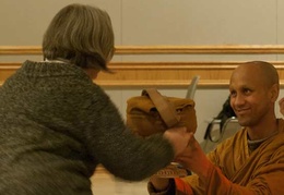 Ven. Atulo's mother presents him with his alms bowl