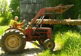 Ajahn Kusalo moves a log with the tractor