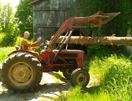 Ajahn Kusalo moves a log with the tractor