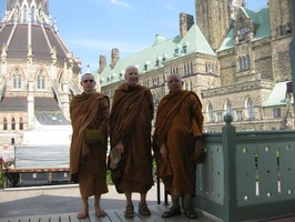 L to R: Tan Thaniyo, LP Viradhammo, and LP Sopa in front of parliament