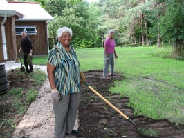 Anoma (front), Priyani (back right), and Dave (back left) do some landscaping to stop the path from flooding