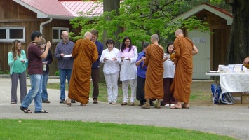 The senior monks collect alms
