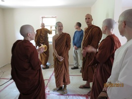 Tan Ajahn Dtun takes a tour of the new mediation hall at Satisaraniya