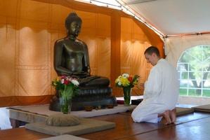 Anagarika in front of Buddha statue